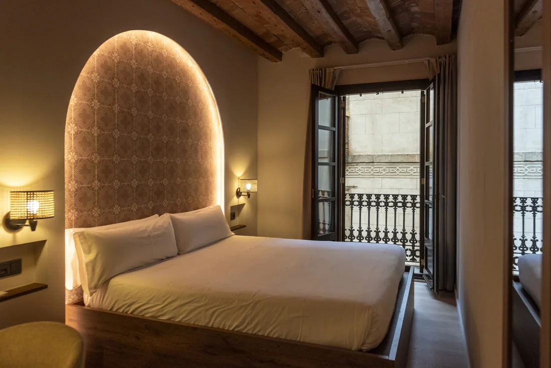 Room with double bed and illuminated headboard