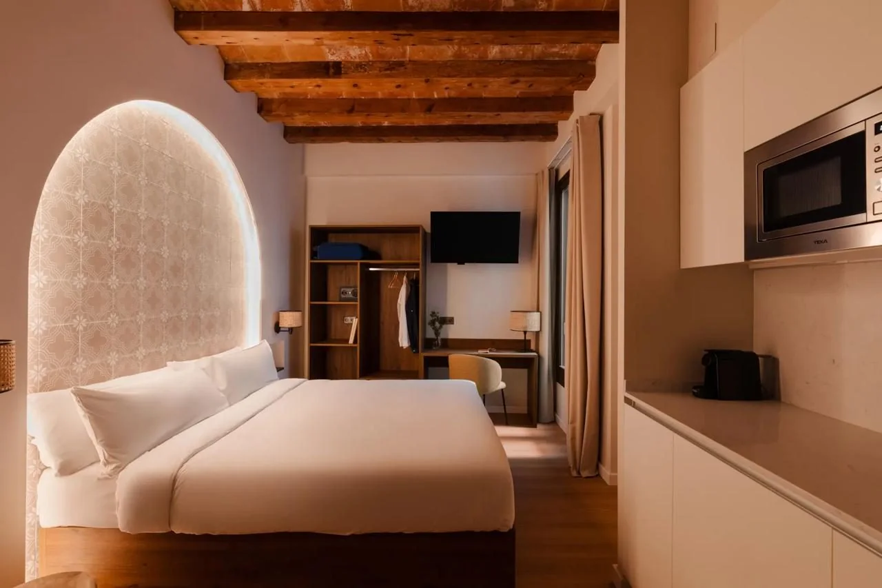 Double bed with illuminated headboard in the studio